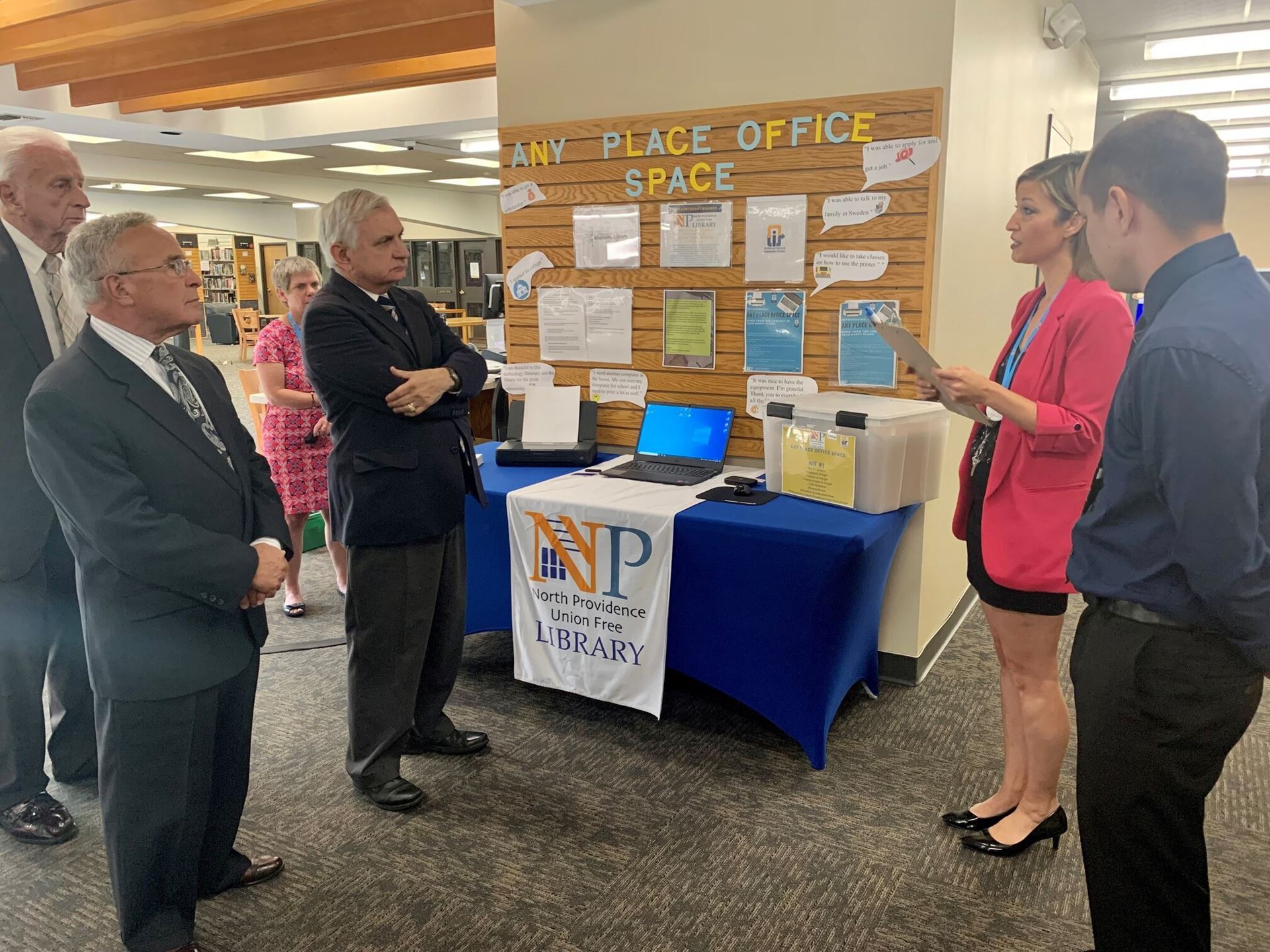 Senator Jack Reed standing in the North Providence Union Free Library speaking with director Stef Blankenship about their "Any Space Office Place" project.